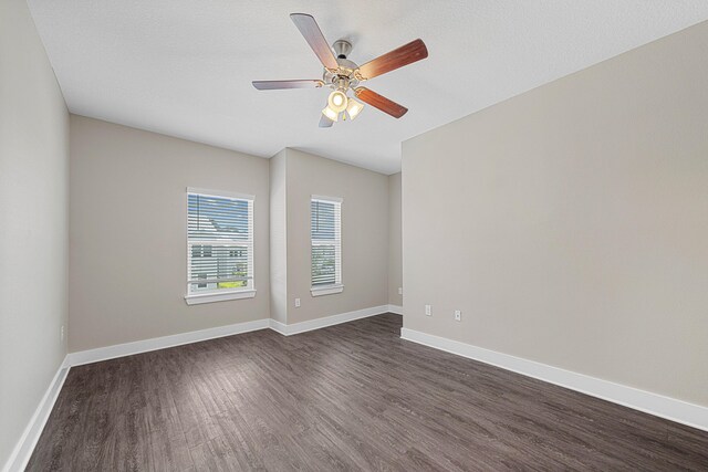 182 N Sand Palm Rd, Freeport, FL 32439 - spare room with dark wood-style flooring, a ceiling fan, and baseboards