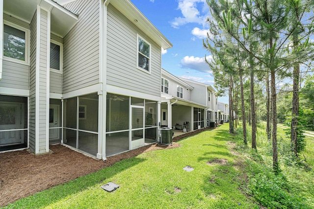 182 N Sand Palm Rd, Freeport, FL 32439 - view of green lawn featuring a sunroom and central AC