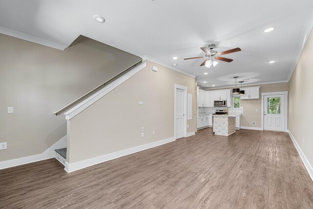 182 N Sand Palm Rd, Freeport, FL 32439 - unfurnished living room featuring crown molding, ceiling fan, wood finished floors, baseboards, and recessed lighting