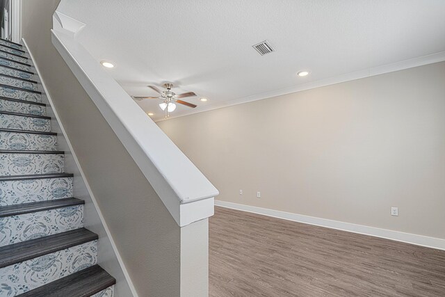 182 N Sand Palm Rd, Freeport, FL 32439 - staircase with a ceiling fan, recessed lighting, wood finished floors, baseboards, and crown molding