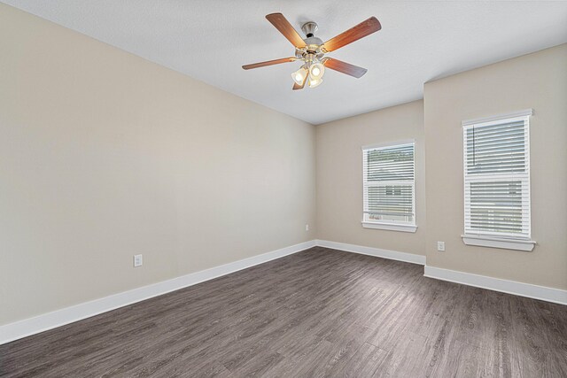 182 N Sand Palm Rd, Freeport, FL 32439 - spare room featuring dark wood finished floors, baseboards, and a ceiling fan