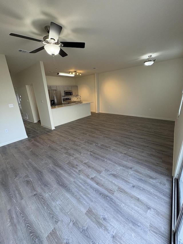 unfurnished living room with hardwood / wood-style flooring and ceiling fan