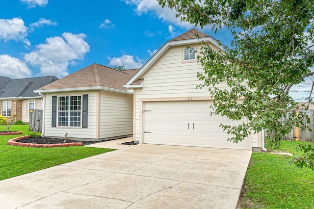 view of front of property with a front lawn and a garage