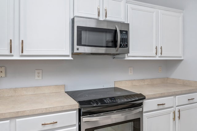 kitchen with white cabinetry and appliances with stainless steel finishes