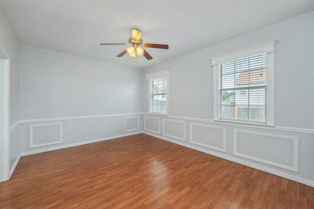 empty room featuring ceiling fan and hardwood / wood-style flooring