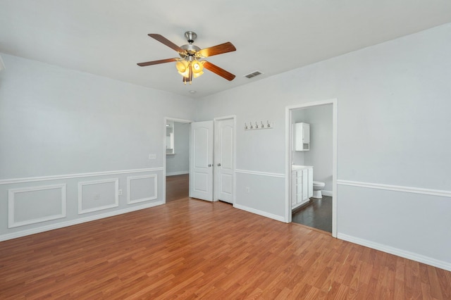 empty room featuring hardwood / wood-style flooring and ceiling fan