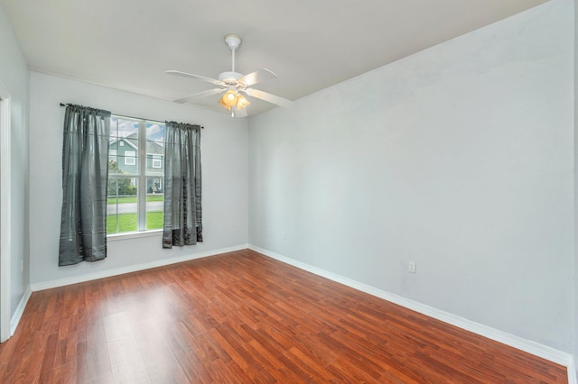 empty room featuring ceiling fan and dark wood-type flooring