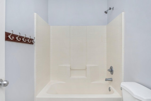 bathroom with shower / bathing tub combination and toilet