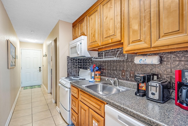 kitchen featuring sink, tasteful backsplash, a textured ceiling, white appliances, and light tile patterned flooring