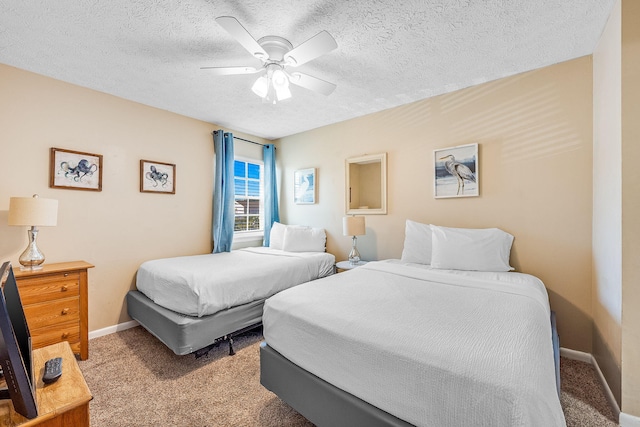 carpeted bedroom with a textured ceiling and ceiling fan