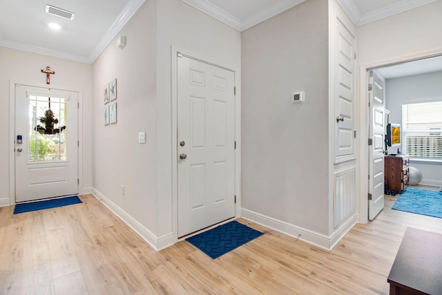 entrance foyer featuring crown molding and light hardwood / wood-style floors