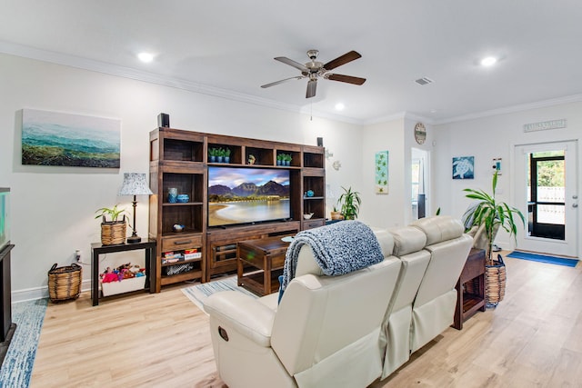 living room featuring ceiling fan, light wood-type flooring, and crown molding