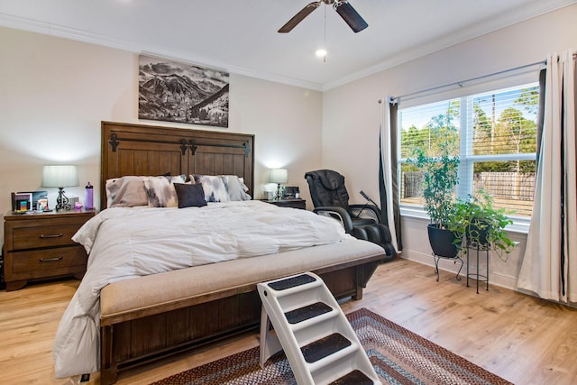 bedroom with ceiling fan, crown molding, and light hardwood / wood-style floors