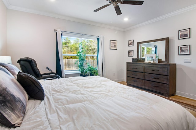 bedroom with ceiling fan, ornamental molding, and light hardwood / wood-style flooring