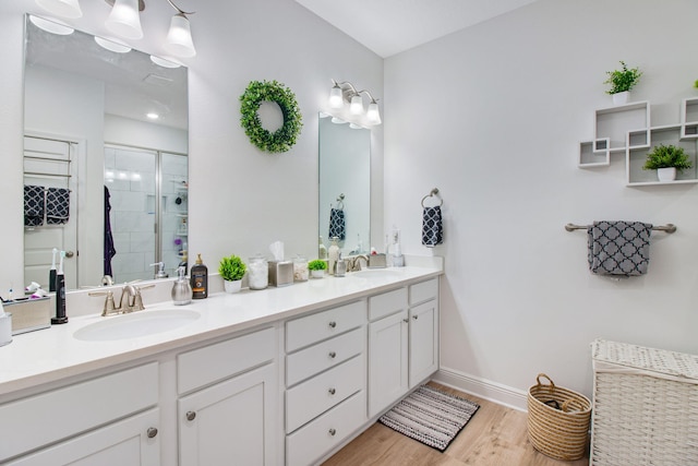 bathroom featuring vanity, wood-type flooring, and walk in shower