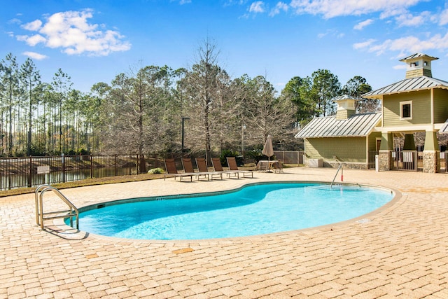 view of swimming pool featuring a patio area