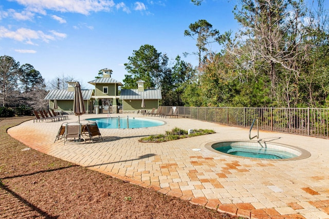 view of pool with a patio area and a hot tub