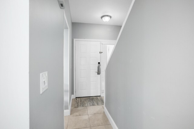 corridor with light tile patterned floors