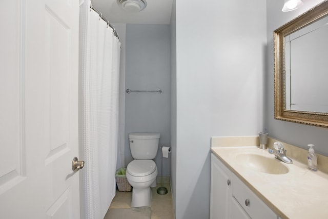 bathroom featuring toilet, vanity, and tile patterned floors