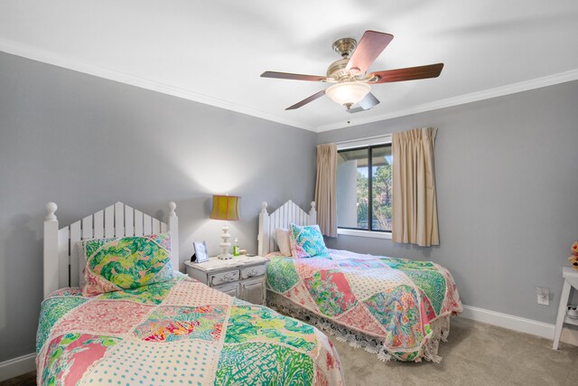 carpeted bedroom featuring ceiling fan and ornamental molding