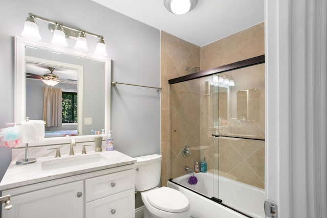 full bathroom featuring vanity, toilet, ceiling fan, and enclosed tub / shower combo