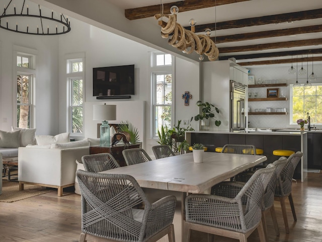 dining room with beamed ceiling and hardwood / wood-style flooring