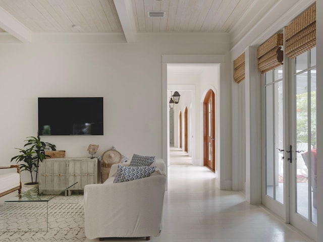 living room with beam ceiling, french doors, and wooden ceiling