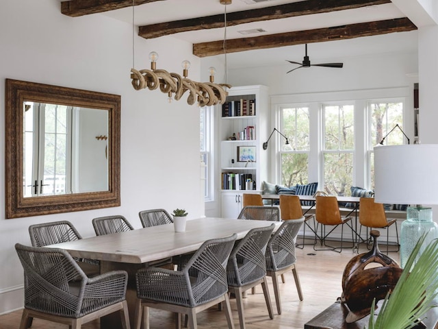 dining space featuring beam ceiling, ceiling fan, and light hardwood / wood-style floors