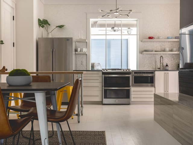 kitchen featuring pendant lighting, white cabinetry, and appliances with stainless steel finishes