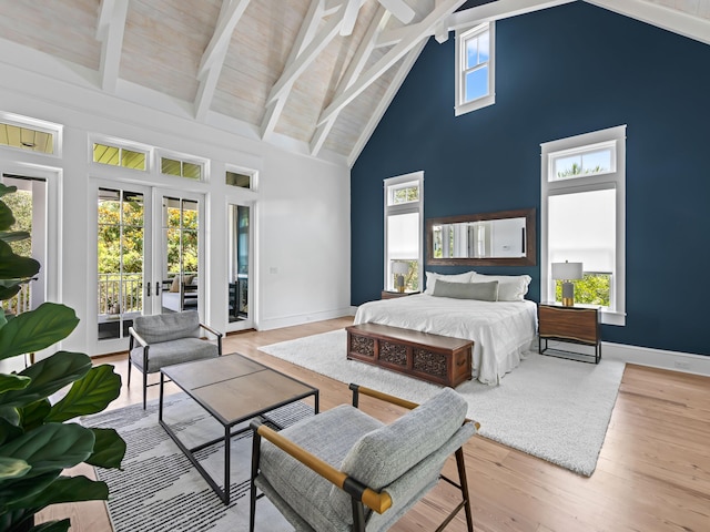 107 E Bermuda Dr, Santa Rosa Beach, FL 32459 - bedroom with high vaulted ceiling, access to outside, wood finished floors, beamed ceiling, and french doors