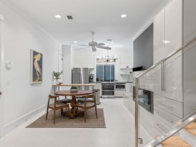 107 E Bermuda Dr, Santa Rosa Beach, FL 32459 - dining area with ceiling fan, recessed lighting, crown molding, and a chandelier