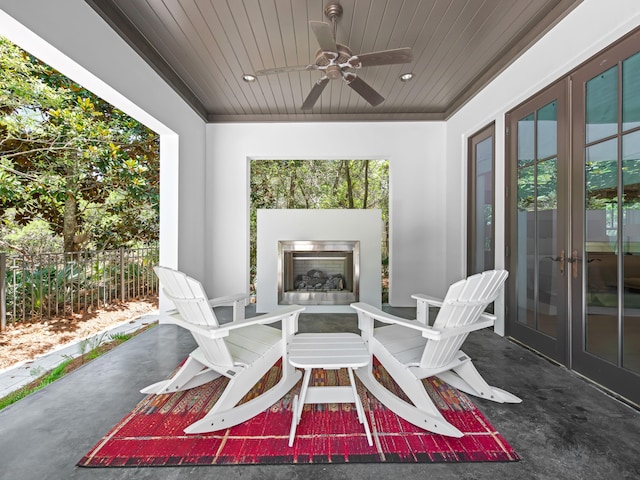 107 E Bermuda Dr, Santa Rosa Beach, FL 32459 - view of patio / terrace featuring exterior fireplace, a ceiling fan, and french doors