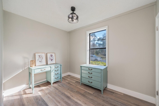 interior space featuring hardwood / wood-style flooring and a textured ceiling