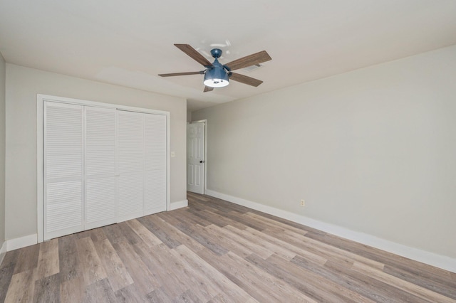 unfurnished bedroom featuring ceiling fan, a closet, and light hardwood / wood-style floors