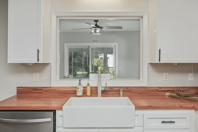 kitchen with stainless steel dishwasher, ceiling fan, sink, and white cabinets