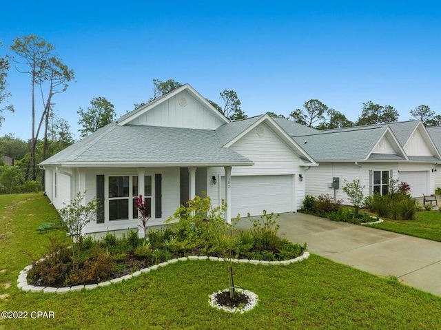 view of front of house with a front lawn and a garage