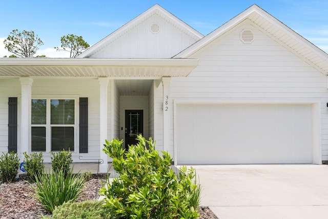 view of front of home featuring a porch and a garage