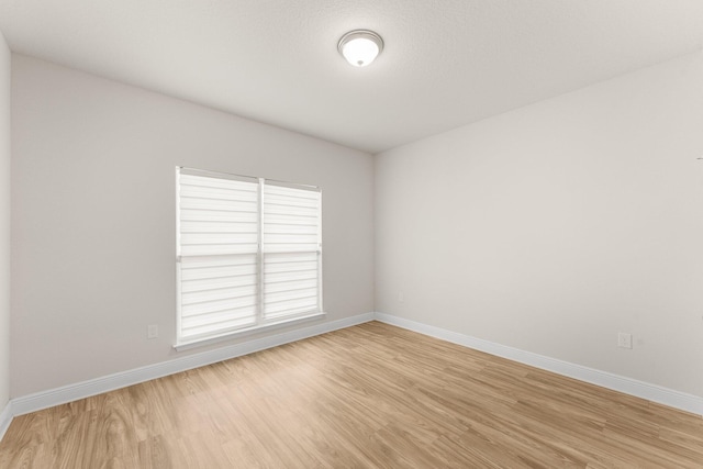 unfurnished room with light hardwood / wood-style flooring