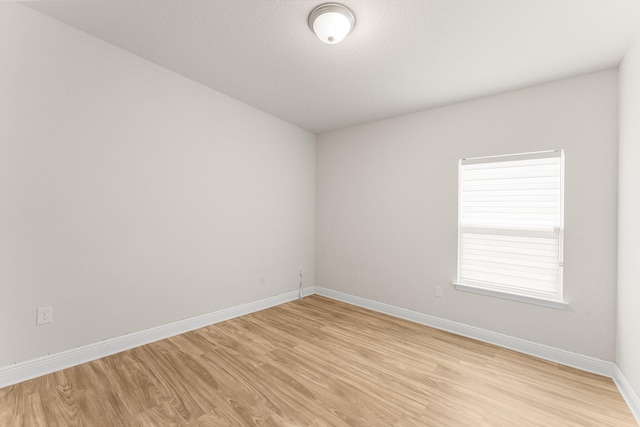 unfurnished room with light hardwood / wood-style flooring