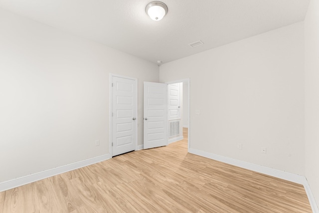 unfurnished room featuring light hardwood / wood-style floors