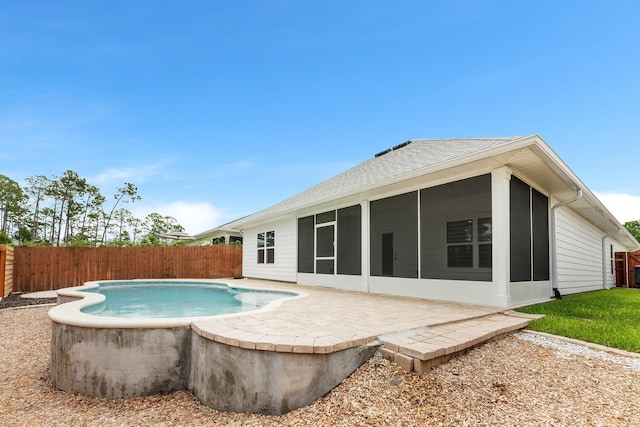 view of pool with a patio area and a sunroom