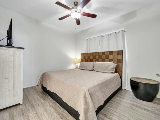 bedroom featuring light hardwood / wood-style flooring and ceiling fan