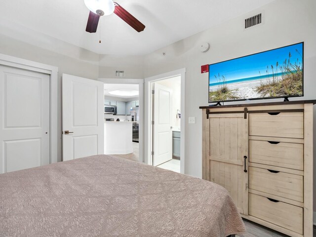 unfurnished bedroom with connected bathroom and ceiling fan