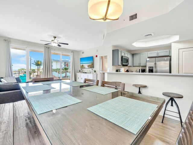 dining space featuring ceiling fan and light hardwood / wood-style floors