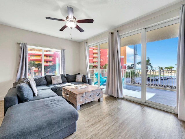 living room with ceiling fan and light hardwood / wood-style floors