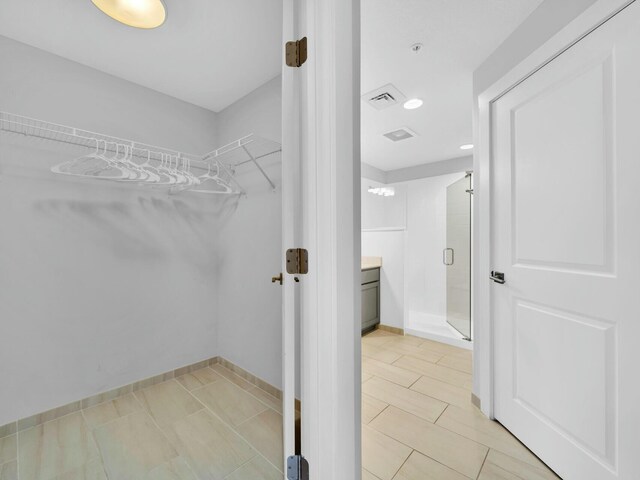 spacious closet featuring light tile patterned floors