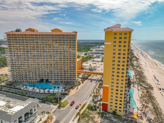 view of building exterior featuring a water view and a view of the beach