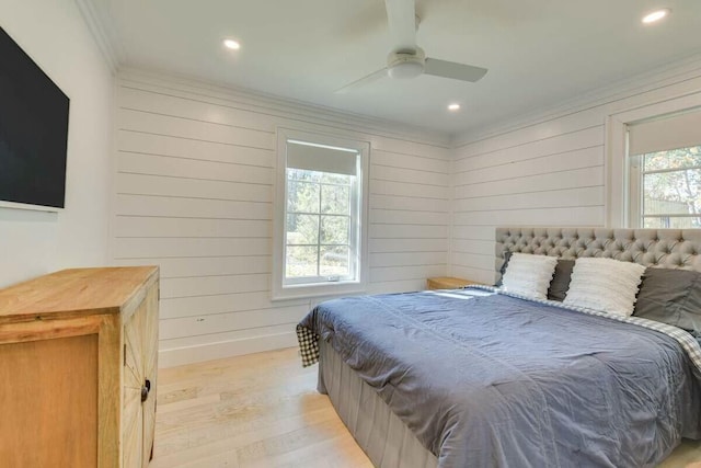 bedroom with wooden walls, baseboards, crown molding, light wood-type flooring, and recessed lighting