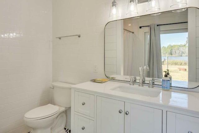 full bath featuring toilet, curtained shower, tile walls, and vanity