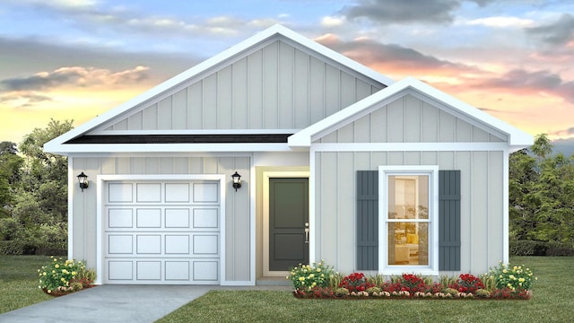 view of front facade with a yard and a garage